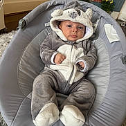 Eris joined the competition — help win amazing prizes! baby, infant, onesie, animal_costume, baby_seat, gray, white, plush, cute, indoors, carpet, plant, decor, face, portrait, clothing, child, cozy, relaxed, young