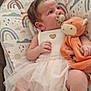 Kataleya participe au concours pour gagner de l'argent avec cette photo : baby, infant, pacifier, plush_toy, fox, tutu_dress, cushion, rainbow_pattern, indoor, child, cute, soft_toy, seat, fabric, clothing, newborn, person, comfort, relaxed, colorful