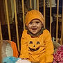 Cléorose participe au concours pour gagner de l'argent avec cette photo : baby, child, pumpkin_costume, smiling, playpen, toy, blanket, orange, hat, happy, cute, indoors, face, person, infant, clothing, costume, sitting, festive, holiday