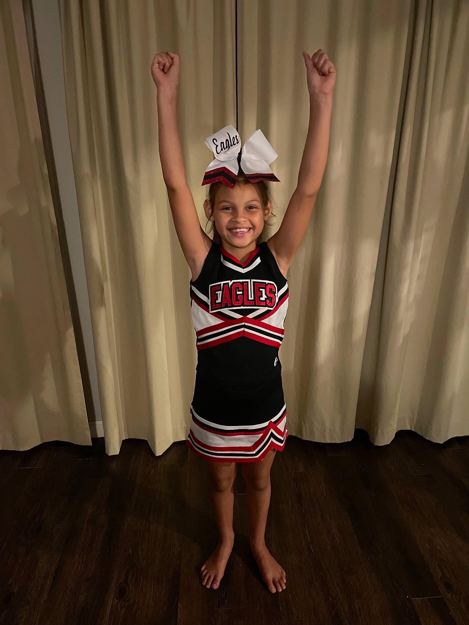 Giana is registered to the contest to win money with this photo: child, curtain, entertainment, event, flash_photography, flooring, happy, human_leg, joy, knee, leg, person, shorts, sleeve, smile, sportswear, t_shirt, thigh, toddler, trunk