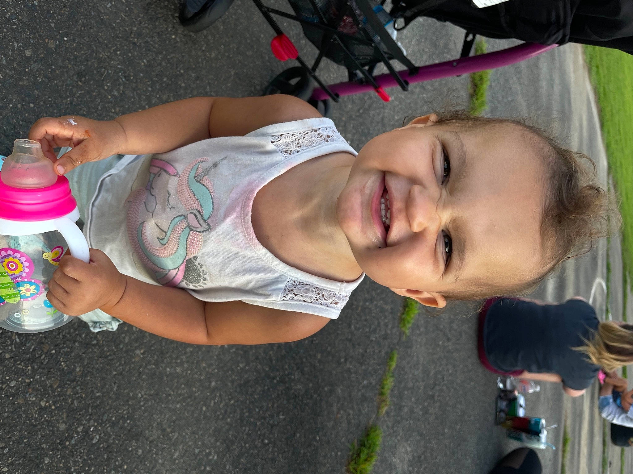 Kylie is registered to the contest to win money with this photo: abdomen, arm, baby_products, chest, child, drinking, drinkware, fun, happy, human_leg, joy, leisure, mouth, person, plastic_bottle, skin, smile, thigh, tire, toddler