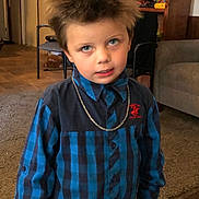 Samuel is registered to the contest to win money with this photo: blue_eyes, books, boy, carpet, casual_pose, chair, checkered_shirt, child, couch, expression, furniture, hair, home, indoor, portrait, room, shelf, silver_chain, wooden_floor, young_person