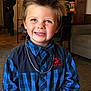 background, blue_eyes, boy, carpet, casual, checkered_pattern, child, cute, furniture, happy, home, indoor, living_room, man, necklace, person, portrait, shirt, smile, spiky_hair