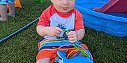 Graham joined the competition — help win amazing prizes! backyard, barefoot, blue_whale_toy, child, fence, grass, happy, outdoor, person, play, playground, pool, shirt, shorts, slide, summer, sunny, toddler, toy, water_toy