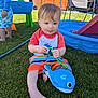 backyard, barefoot, blue_whale_toy, child, fence, grass, happy, outdoor, person, play, playground, pool, shirt, shorts, slide, summer, sunny, toddler, toy, water_toy