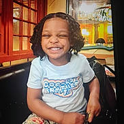 Legend joined the competition — help win amazing prizes! child, smiling, happy, indoor, curly_hair, tshirt, denim_pants, bench, window, lamp, reflection, wood, seat, person, portrait, casual_clothing, joyful, cute, fashion, light