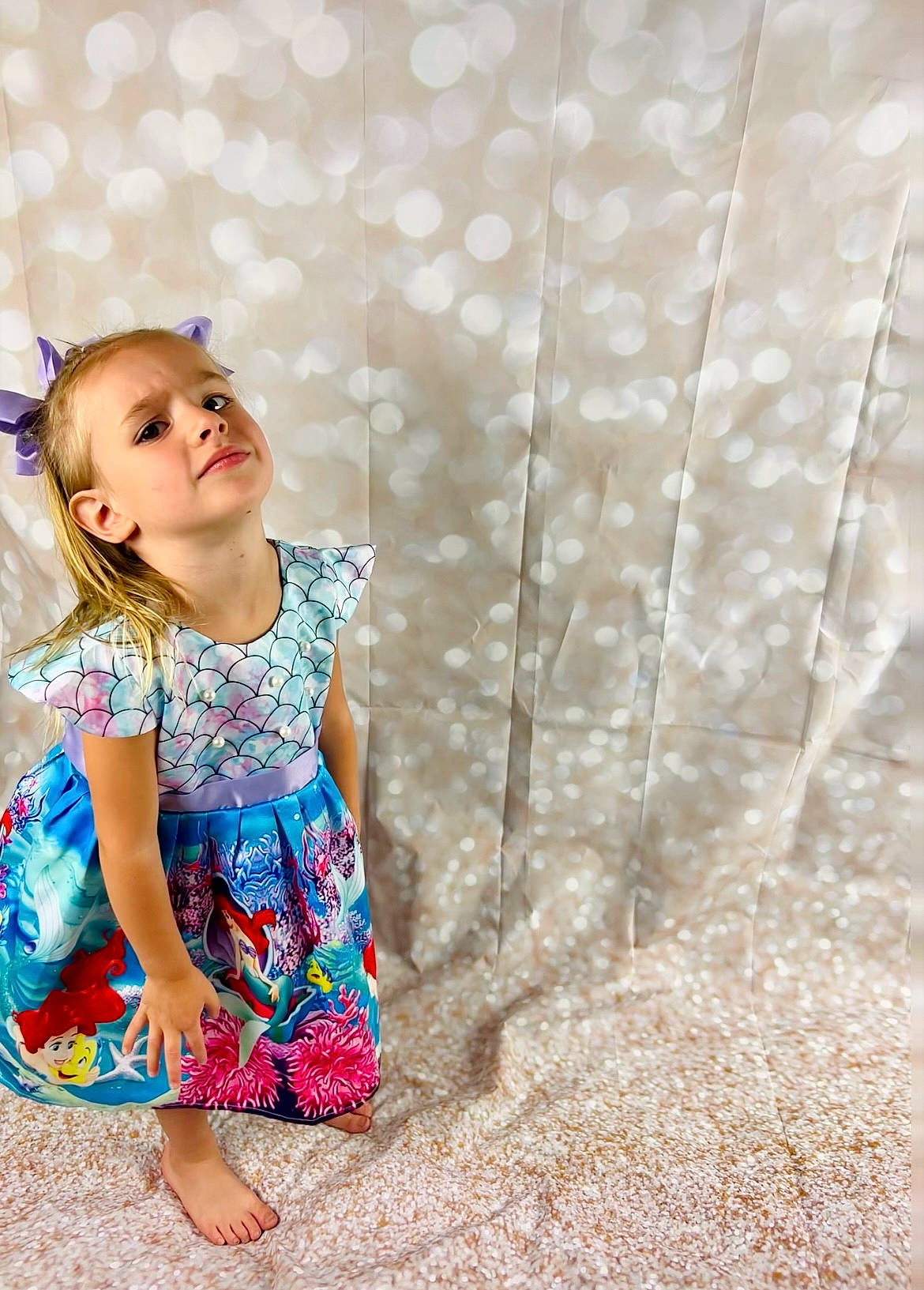 Amelia is registered to the contest to win money with this photo: baby_toddler_clothing, barefoot, child, day_dress, dress, fun, grass, happy, joy, leisure, magenta, pattern, people_in_nature, person, plant, portrait_photography, sitting, skin, toddler, tree