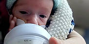 Charles participe au concours pour gagner de l'argent avec cette photo : baby, bottle, caring, child, closeup, cozy, cute, feeding, hand, human_hand, indoors, infant, knit_hat, milk, newborn, portrait, relaxing, small, soft_focus, warm
