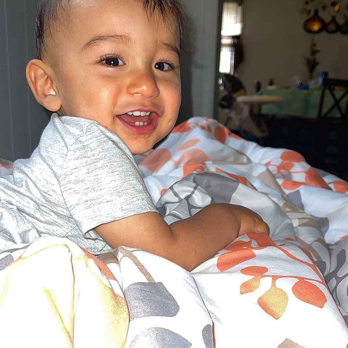 Kenzo is registered to the contest to win money with this photo: baby_toddler_clothing, cheek, child, comfort, facial_expression, finger, gesture, hairstyle, happy, human_body, iris, mouth, muscle, neck, nose, person, skin, sleeve, smile, t_shirt