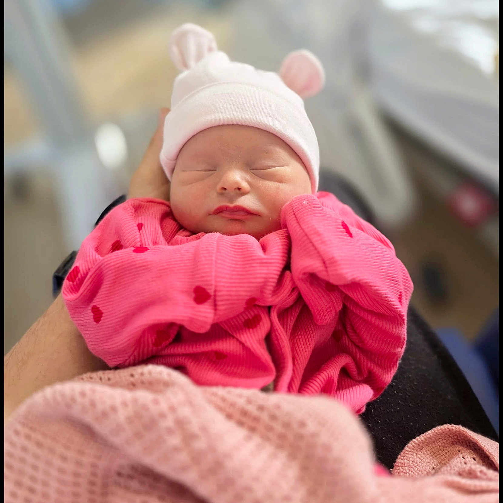 Delores is registered to the contest to win money with this photo: baby, babywearing, bear_ears, blanket, closeup, clothing, cute, hands, hat, indoor, infant, newborn, peaceful, person, pink, portrait, rest, sleeping, soft, warm