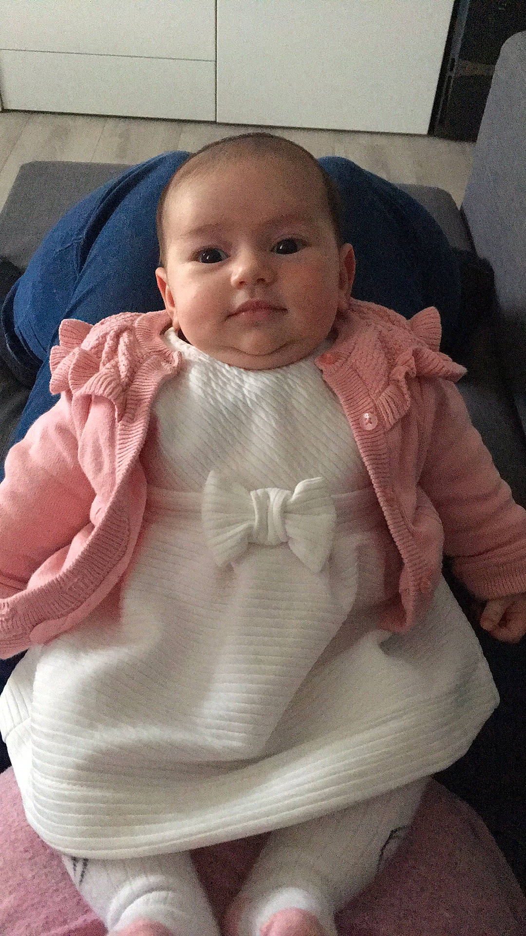 Giulia participe au concours pour gagner de l'argent avec cette photo : arm, baby, cheek, child, electronic_device, face, head, outerwear, person, pink, product, sitting, skin, smile, toddler