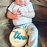 Gunnar joined the competition — help win amazing prizes! baby, infant, two_months, pajamas, couch, plush, cute, child, portrait, sitting, wooden_sign, hand, face, expression, indoors, cozy, clothing, footed_pajamas, young_baby, smiling
