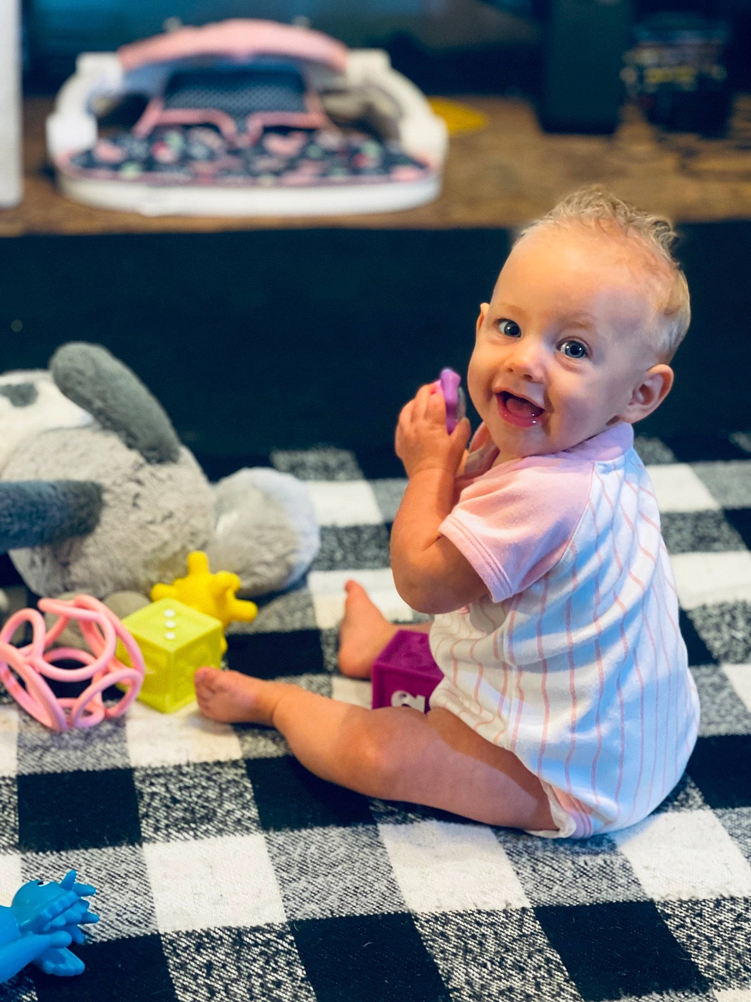 Aspyn is registered to the contest to win money with this photo: baby, baby_toddler_clothing, blue, child, event, flooring, fun, happy, leisure, person, photograph, play, product, recreation, sitting, smile, stuffed_toy, t_shirt, toddler, toy