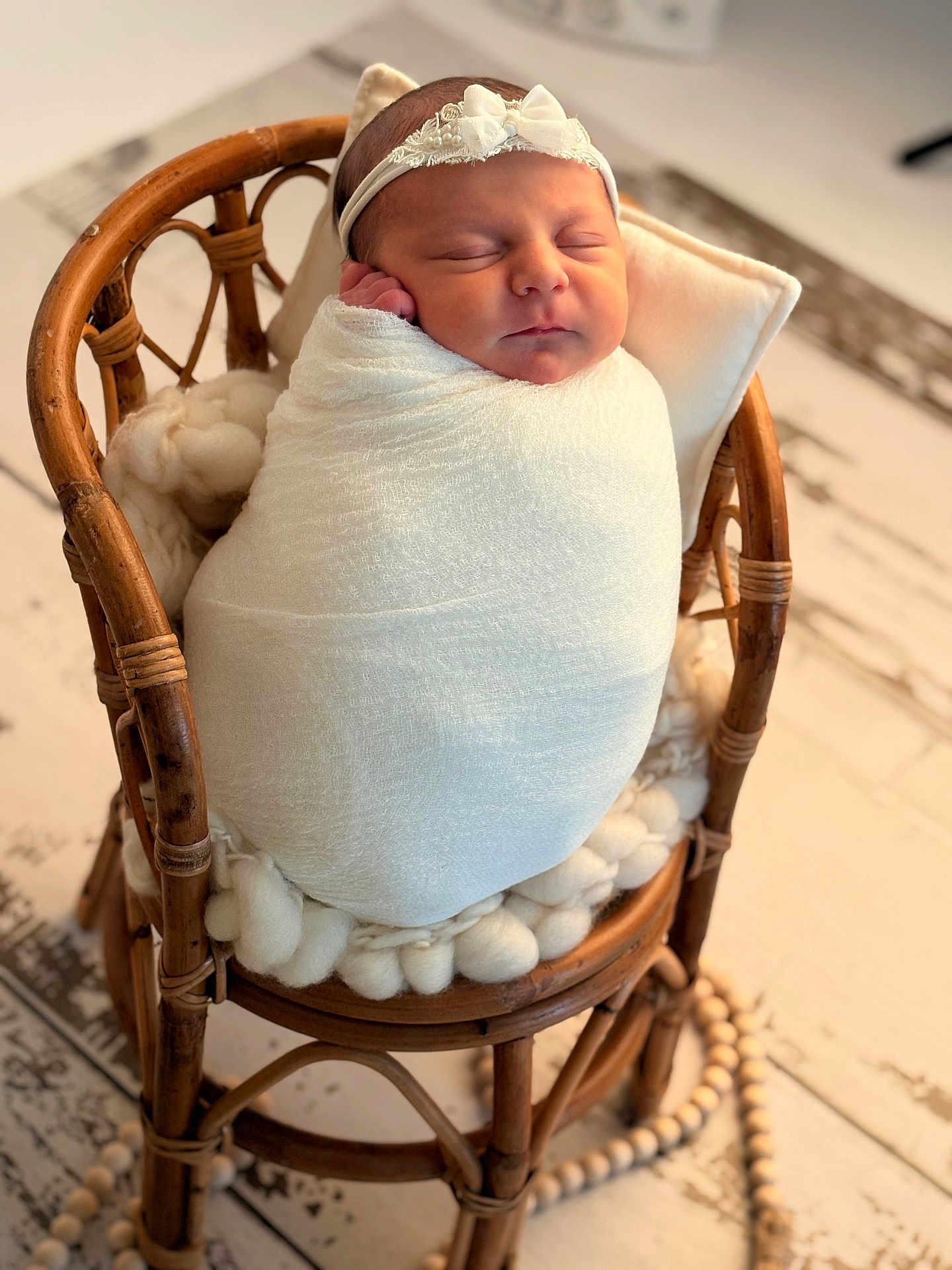 Eleya participe au concours pour gagner de l'argent avec cette photo : newborn, baby, sleeping, wrapped, blanket, headband, chair, wooden_chair, cushion, cozy, indoors, portrait, infant, peaceful, soft_texture, cute, resting, closeup, warm, decor