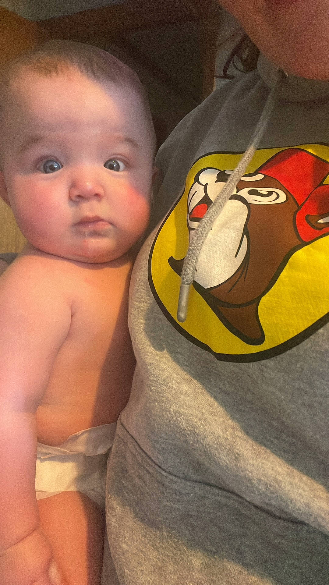 Austyn is registered to the contest to win money with this photo: arm, baby, bird, cheek, eyelash, facial_expression, finger, gesture, happy, human_body, joint, lip, mammal, mouth, neck, nose, penguin, person, shoulder, stomach