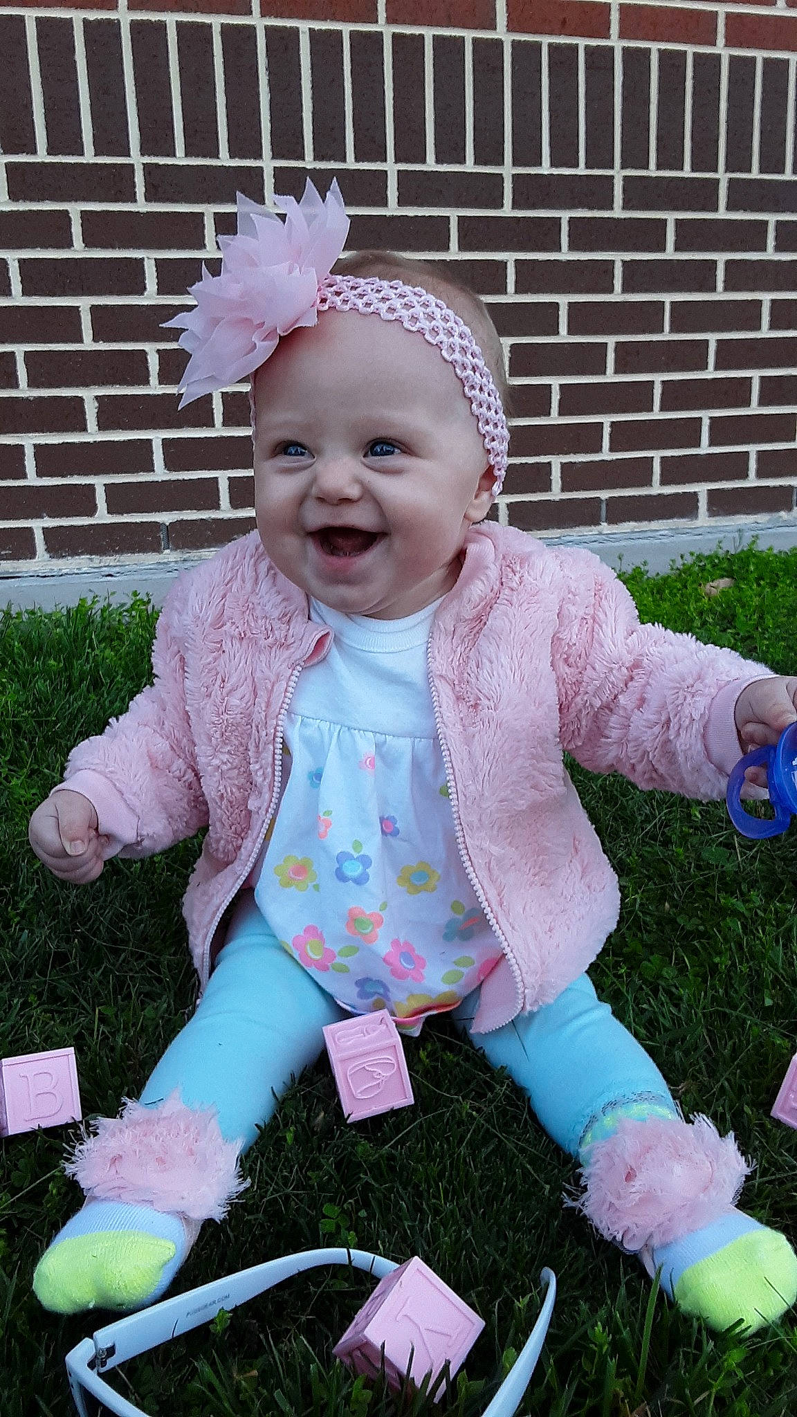 Rhea is registered to the contest to win money with this photo: baby, baby_toddler_clothing, child, costume, grass, headgear, headwear, joy, person, pink, play, toddler