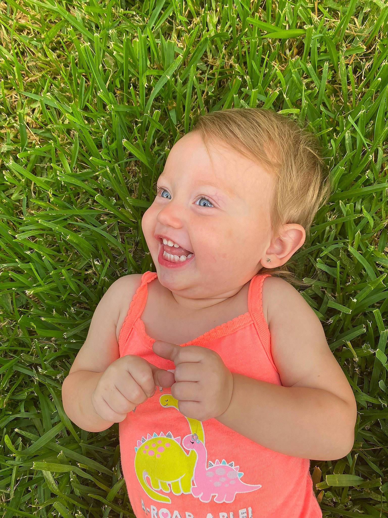 Ava-grace is registered to the contest to win money with this photo: baby, baby_toddler_clothing, eye, face, facial_expression, finger, fun, gesture, grass, happy, human_body, leaf, nose, people_in_nature, person, plant, skin, smile, thumb, toddler