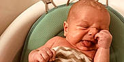 Morgan is registered to the contest to win money with this photo: baby, infant, face, skin, tongue, hand, arm, bath, bathroom, seat, cushion, pattern, zigzag, expression, newborn, cute, child, water, wet, human