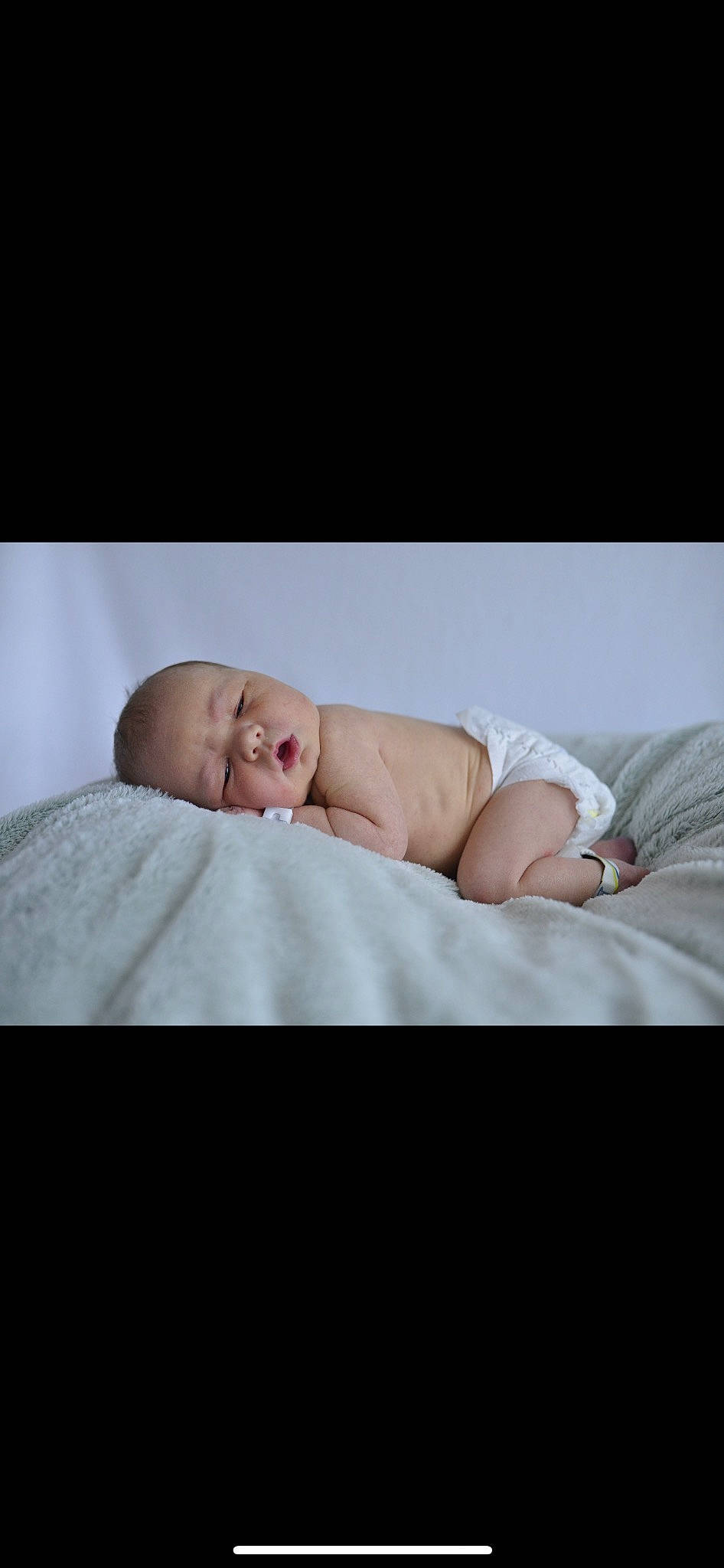 Carson is registered to the contest to win money with this photo: baby, baby_toddler_clothing, bedding, child, collar, comfort, face, flash_photography, flesh, fur, linens, person, photo_shoot, portrait, portrait_photography, room, sitting, skin, sleeve, toddler