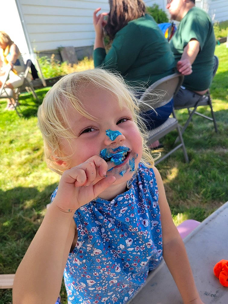 Olive is registered to the contest to win money with this photo: baby, baby_toddler_clothing, blue, chair, community, electric_blue, event, fun, grass, grass_family, green, happy, leisure, people, person, photograph, plant, recreation, summer, t_shirt