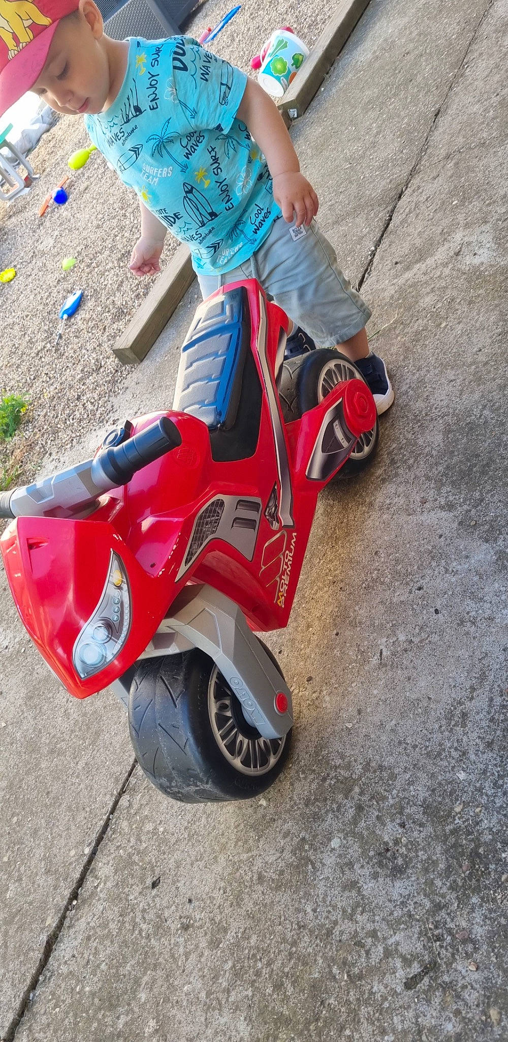 Lyam a rejoint le concours — aidez-le/la à gagner de superbes lots ! asphalt, automotive_design, automotive_exterior, automotive_lighting, automotive_tire, automotive_wheel_system, bumper, electric_blue, fender, headwear, human_leg, jeans, motor_vehicle, person, recreation, riding_toy, rolling, street_fashion, tire, toy