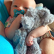 Skylar joined the competition — help win amazing prizes! arm, baby, blue_shirt, child, closeup, clothing, comfort, cuddly, elephant_toy, face, floral_watchband, hand, indoor, infant, pacifier, person, skin, soft_toy, stuffed_animal, watch