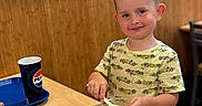 Maksym joined the competition — help win amazing prizes! boy, casual, child, cup, dessert, eating, food, fries, happy, indoor, light, pepsi, person, restaurant, smile, spoon, table, tray, wooden_wall, yellow_shirt