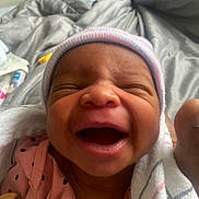 Zyana joined the competition — help win amazing prizes! newborn, baby, smiling, hat, blanket, infant, close_up, face, pink_clothing, sleepwear, happy, wrapped, cozy, bed, indoors, cute, child, person, newborn_clothing, soft