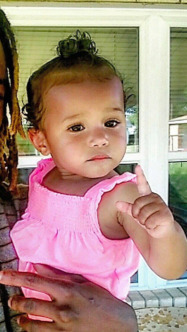 Oaklee is registered to the contest to win money with this photo: baby, baby_toddler_clothing, cheek, chin, dress, eye, eyelash, gesture, hair, hairstyle, hand, happy, iris, lip, mouth, nose, person, pink, skin, toddler