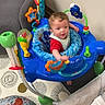 Wyatt is registered to the contest to win money with this photo: activity_center, baby, carpet, child, clothing, colorful, curiosity, cushion, floor, furniture, happy, home, indoor, person, play, seat, smiling, toddler, toy, young