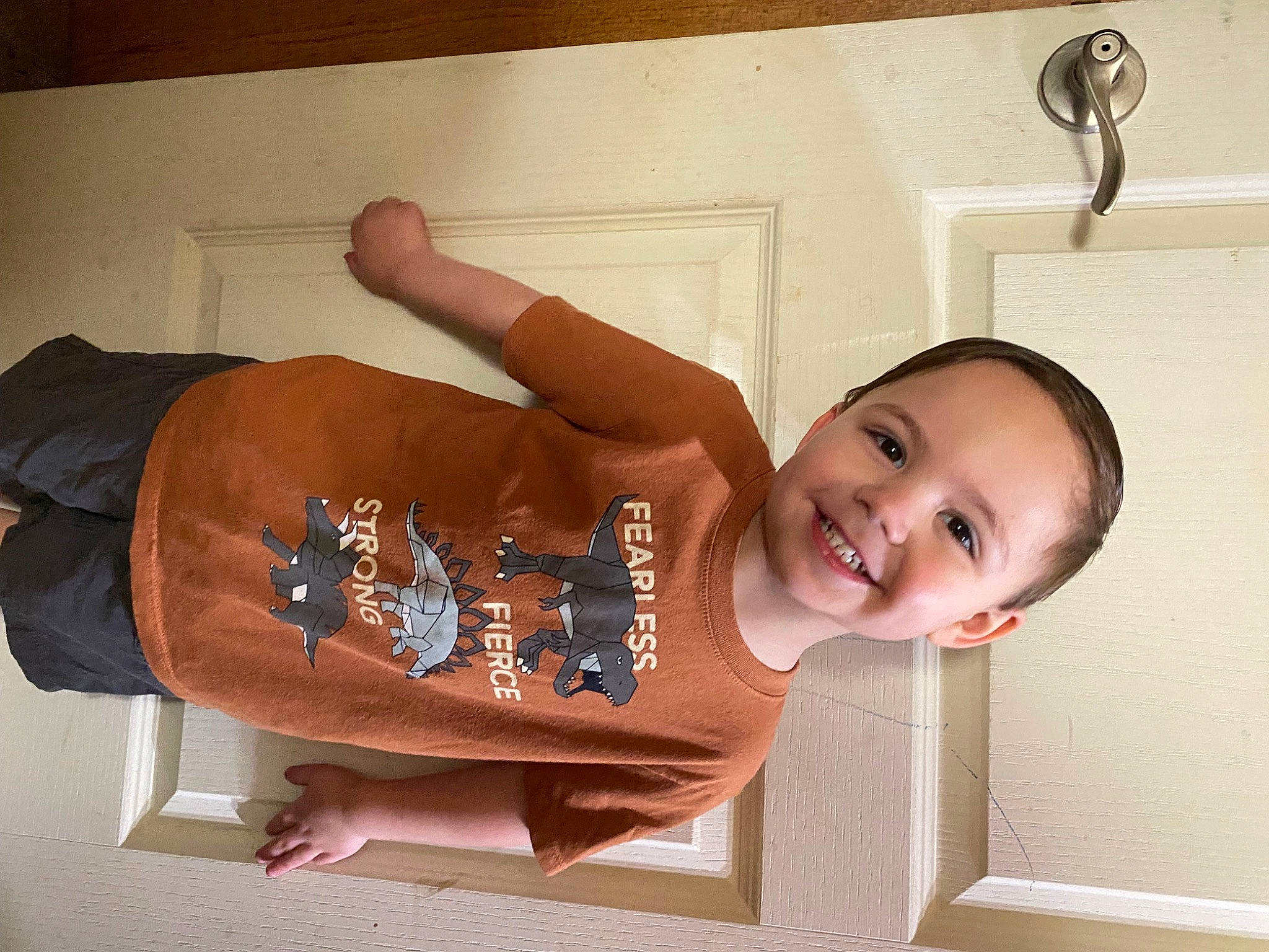 Noah is registered to the contest to win money with this photo: abdomen, baby, ceiling, child, elbow, fashion_accessory, flooring, fun, gesture, happy, joy, pattern, person, room, sleeve, smile, t_shirt, toddler, trunk, waist