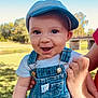 Southern is registered to the contest to win money with this photo: baby, bridge, casual_clothing, child, closeup, daylight, denim_overalls, grass, hand, happy, hat, headwear, holding, nature, outdoor, park, person, portrait, smile, young_child