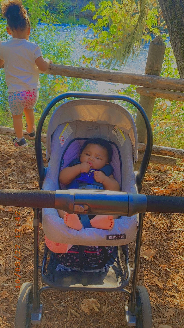 Zendaya is registered to the contest to win money with this photo: baby, baby_toddler_clothing, chair, fun, grass, green, human_settlement, leisure, outdoor_furniture, people_in_nature, person, photograph, plant, product, recreation, shade, shorts, snapshot, sunlight, tints_and_shades