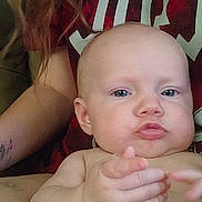 Bryer joined the competition — help win amazing prizes! arm, baby, casual, child, closeup, clothing, diaper, expression, face, hair, hand, indoor, infant, lap, numbers, person, portrait, red_shirt, sitting, skin
