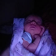 Bryer joined the competition — help win amazing prizes! baby, sleeping, blanket, purple, infant, cozy, hand, face, soft, wrapped, resting, peaceful, child, dark, closeup, newborn, person, quiet, night, comfort