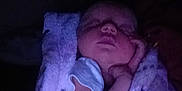 Bryer joined the competition — help win amazing prizes! baby, blanket, child, closeup, comfort, cozy, dark, face, hand, infant, newborn, night, peaceful, person, purple, quiet, resting, sleeping, soft, wrapped