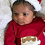 baby, infant, child, face, hat, red_clothing, santa_claus_print, christmas, holiday, cute, soft_blanket, indoor, portrait, newborn, lying_down, festive, winter, young_child, closeup, smiling