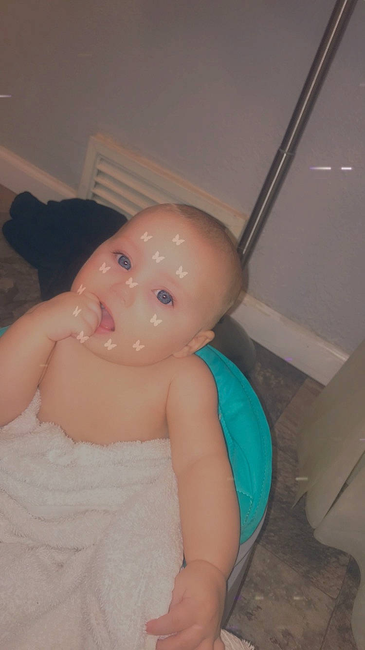 Addilynn is registered to the contest to win money with this photo: abdomen, arm, chest, chin, ear, elbow, eye, eyebrow, flooring, gesture, head, human_body, lip, nail, neck, nose, person, shoulder, thumb, toy