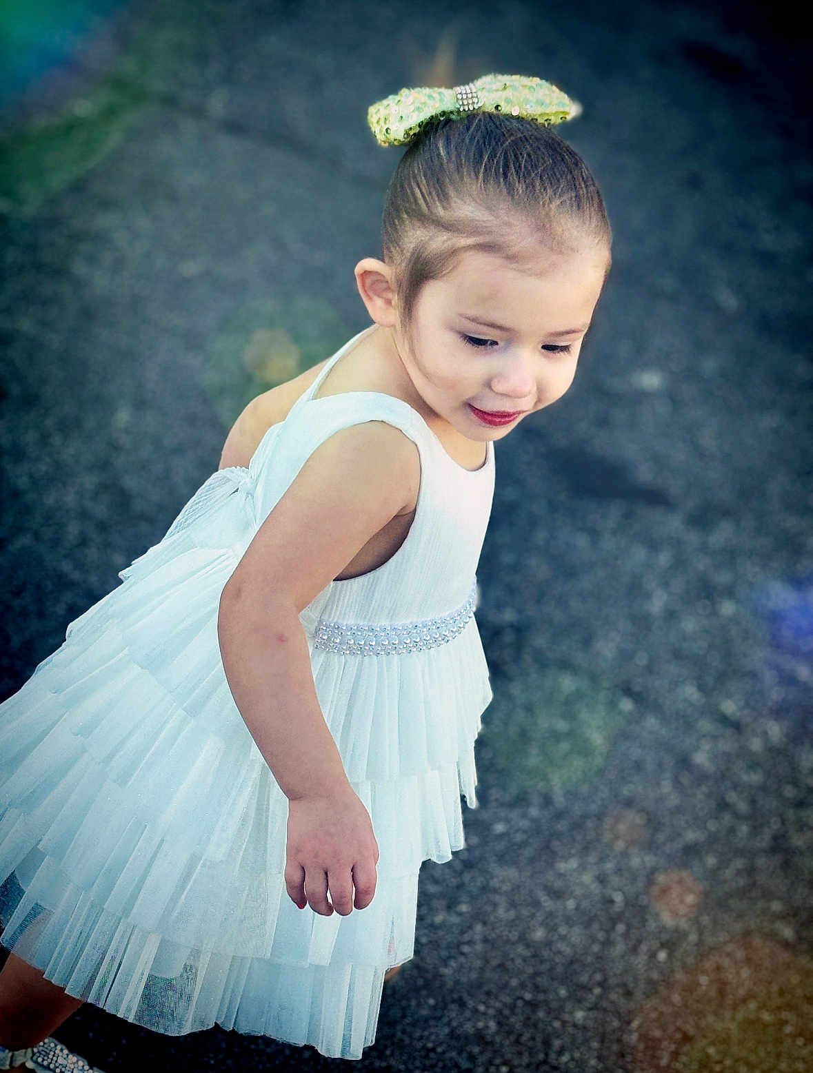 Journii is registered to the contest to win money with this photo: child, girl, white_dress, bow, portrait, outdoor, pavement, cute, smiling, young, fashion, happy, playful, innocent, person, childhood, pretty, sparkle, tiered_dress, daylight