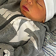 Jasper is registered to the contest to win money with this photo: baby, newborn, sleeping, infant, face, clothing, hat, mittens, blanket, pattern, soft, cute, child, peaceful, resting, portrait, indoors, cozy, closeup, toddler