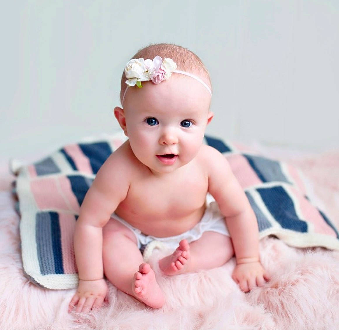 Elle is registered to the contest to win money with this photo: baby, baby_toddler_clothing, cheek, child, comfort, costume_accessory, ear, fashion_accessory, finger, hair_accessory, hand, headband, headgear, headpiece, mouth, nose, person, pink, skin, stomach