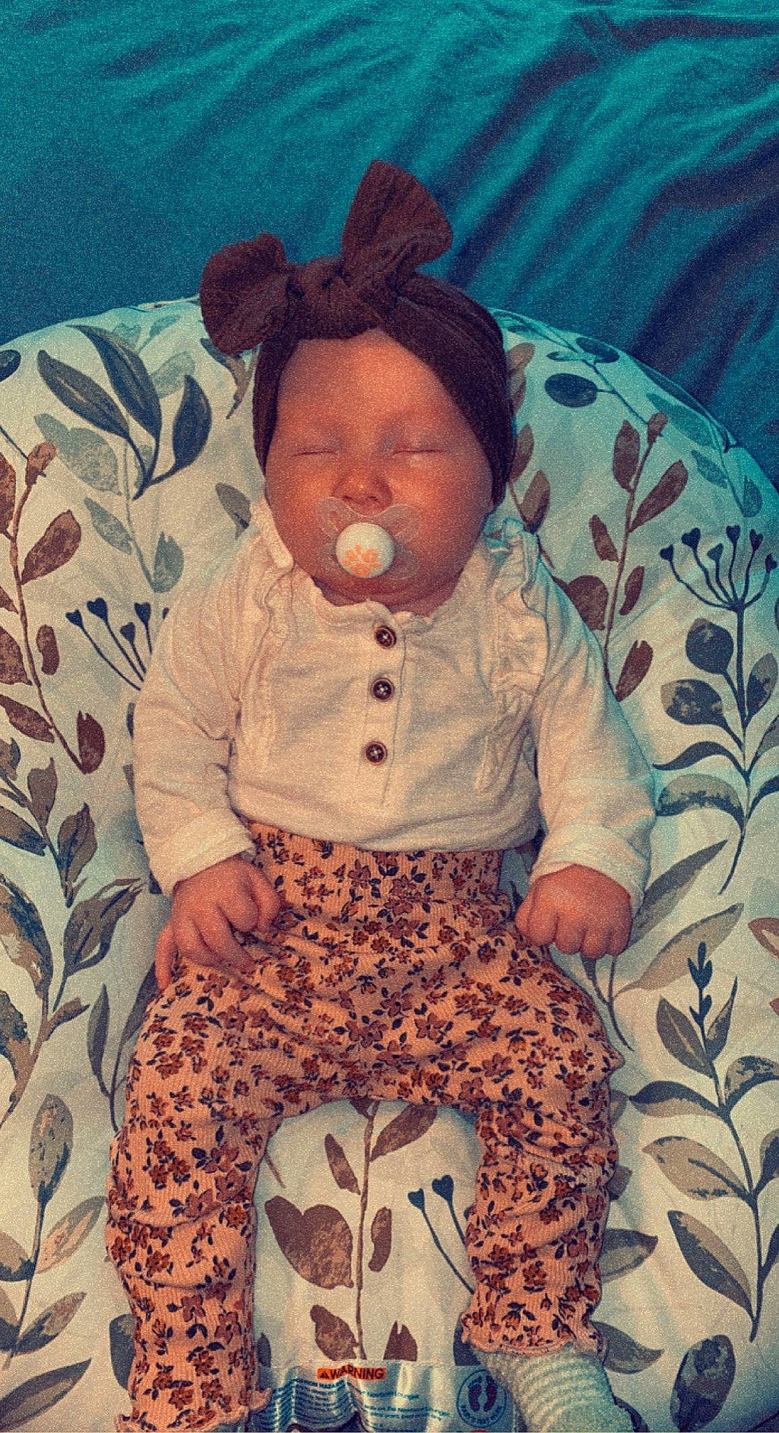 Briar is registered to the contest to win money with this photo: arm, baby, baby_sleeping, baby_toddler_clothing, beauty, child, clothing, comfort, cool, doll, eye, happy, orange, pattern, person, product, sitting, sleeve, textile, thigh