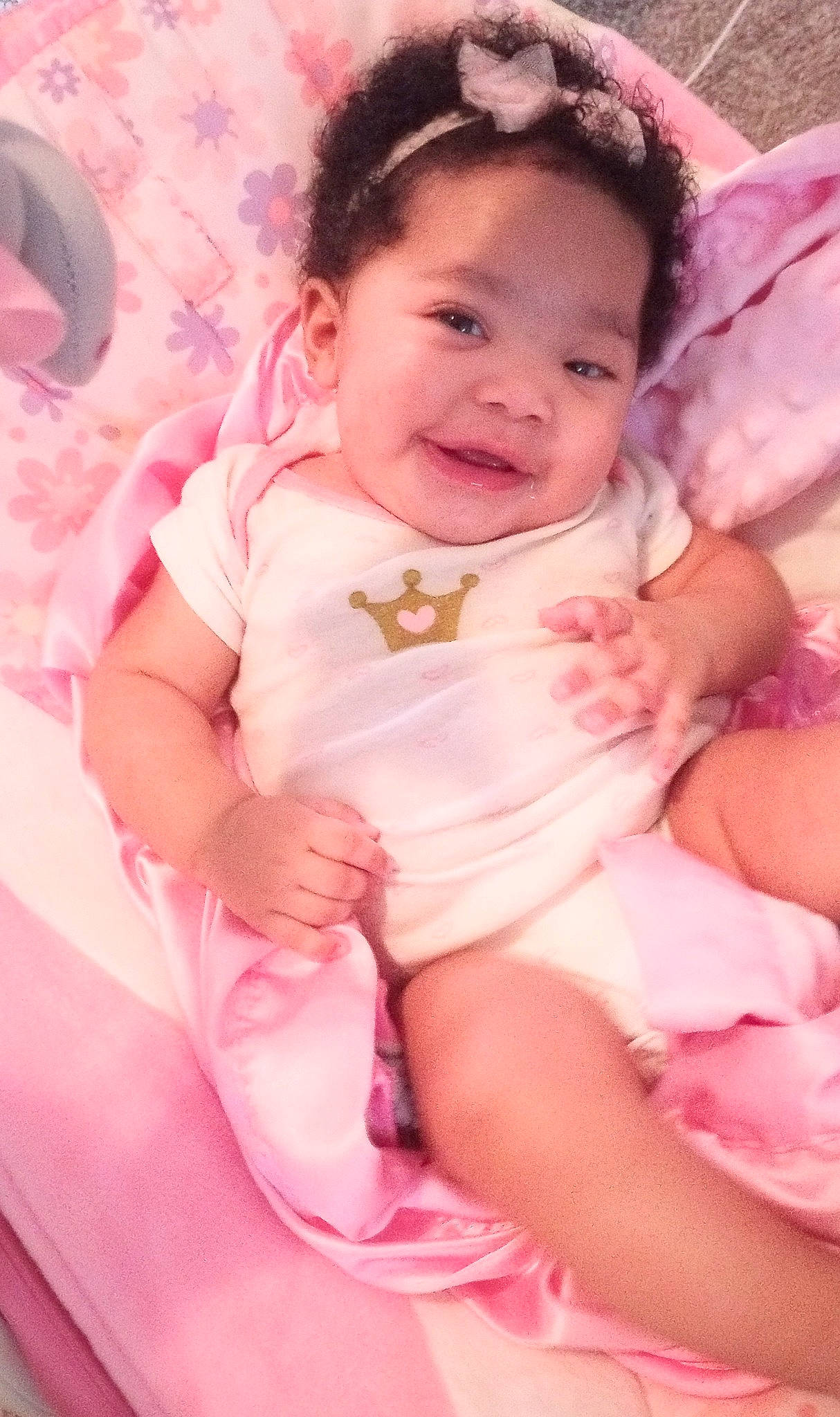 Miracle is registered to the contest to win money with this photo: arm, baby, baby_toddler_clothing, cheek, chin, comfort, eye, face, finger, happy, head, human_body, iris, lip, magenta, mouth, person, pink, skin, smile