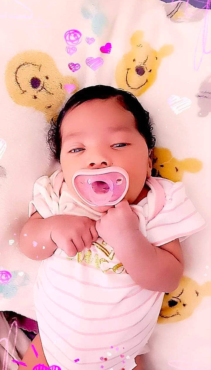 Miracle is registered to the contest to win money with this photo: baby, baby_toddler_clothing, cheek, child, eyelash, facial_expression, gesture, happy, head, mouth, nose, person, pink, playing_with_kids, product, skin, sleeve, textile, toddler, white