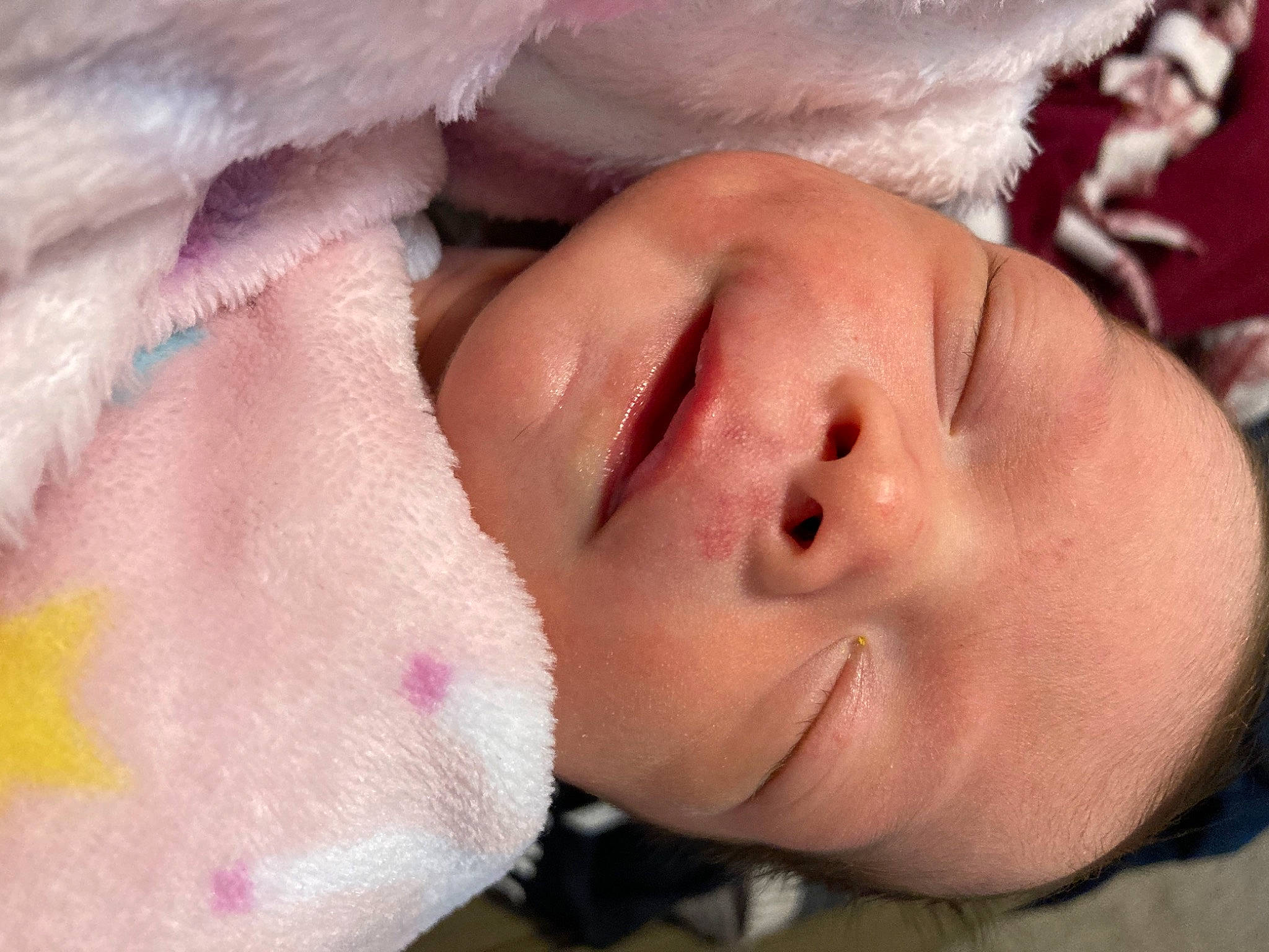 June is registered to the contest to win money with this photo: cheek, chin, ear, eye, eyebrow, eyelash, face, finger, gesture, happy, headgear, human_body, lip, mouth, neck, nose, person, pink, plant, skin