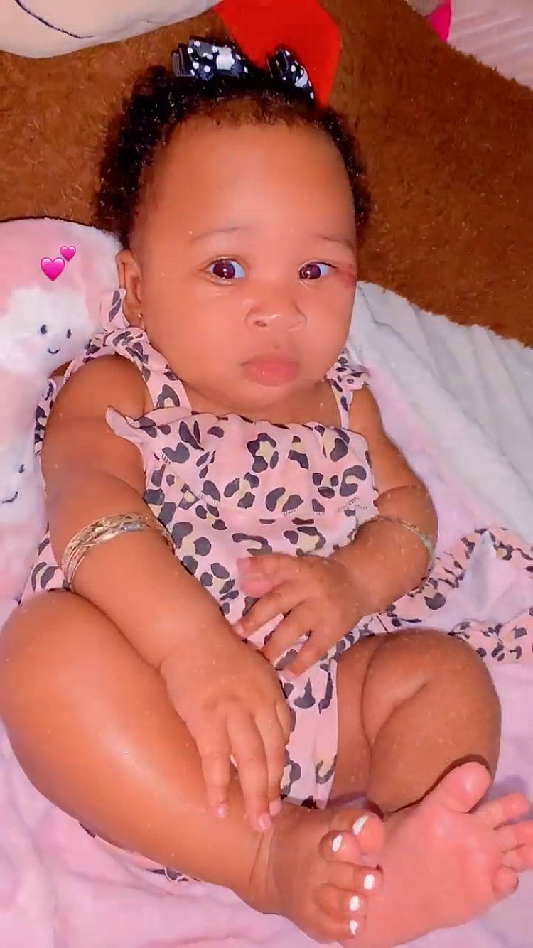 Bailee is registered to the contest to win money with this photo: baby, baby_toddler_clothing, cheek, comfort, eyelash, face, finger, hairstyle, hand, happy, human_body, iris, lip, mouth, neck, nose, person, pink, skin, textile