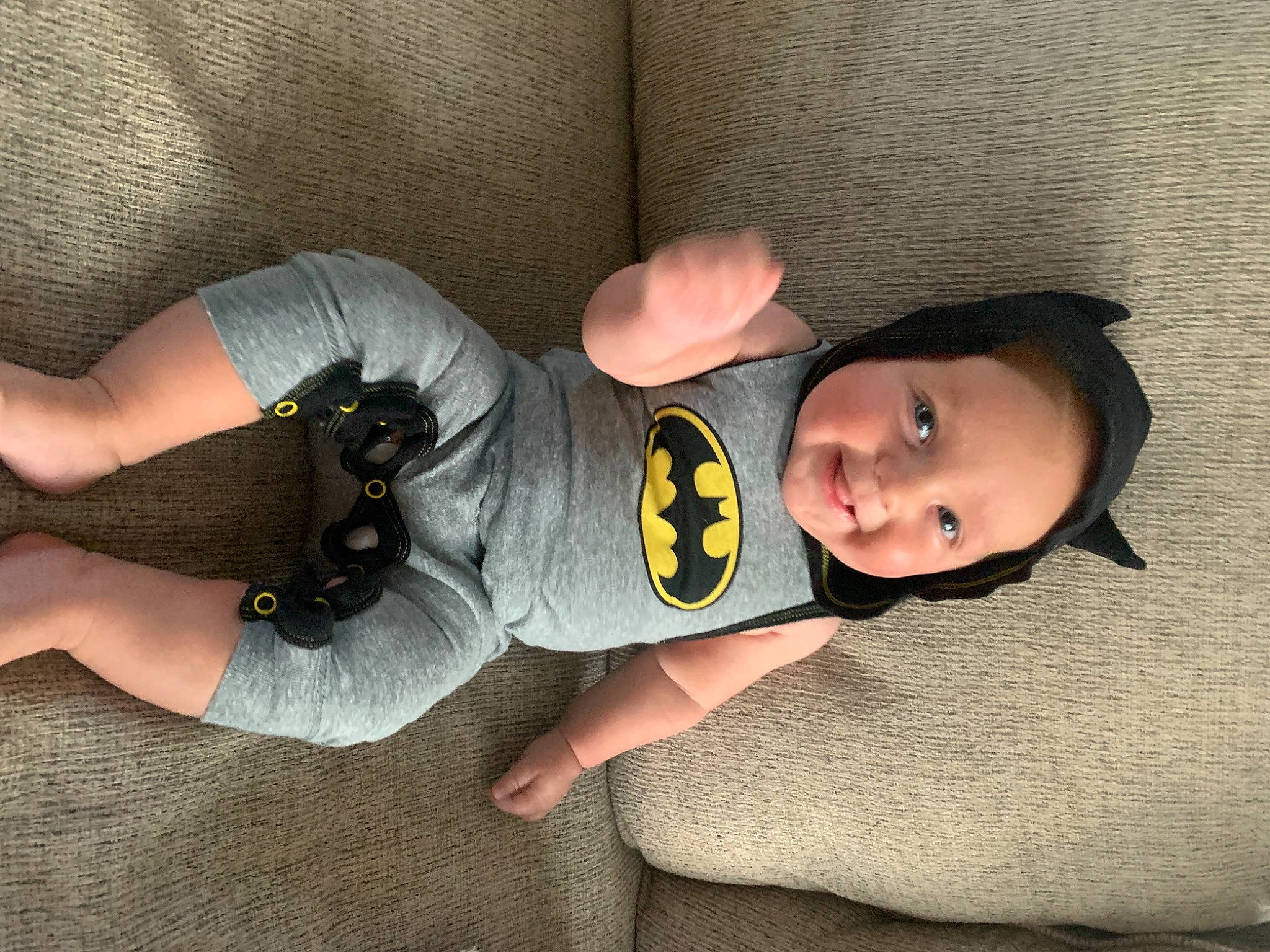 Cade is registered to the contest to win money with this photo: baby, baby_toddler_clothing, child, comfort, elbow, flooring, foot, fun, gesture, human_body, human_leg, joy, knee, leg, person, personal_protective_equipment, sitting, sleeve, sock, thigh