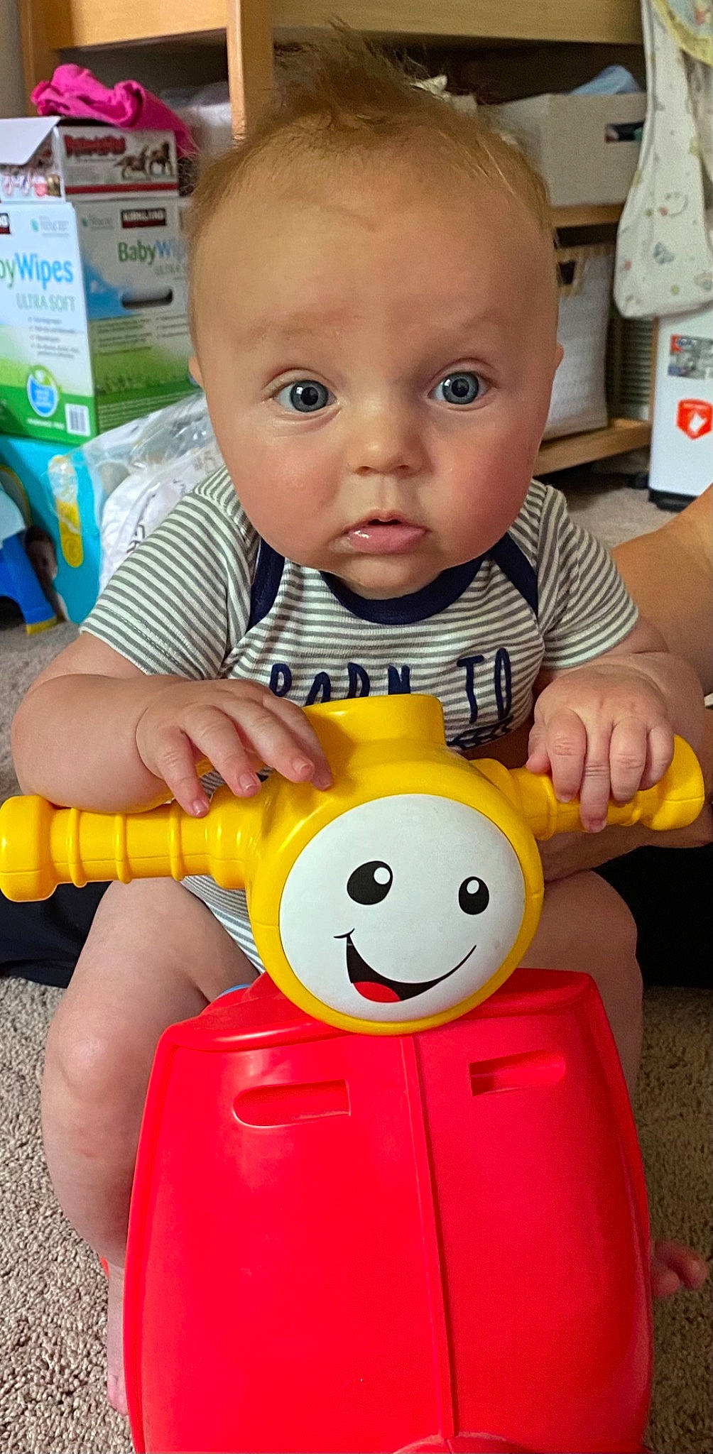 Cade is registered to the contest to win money with this photo: baby, baby_playing_with_toys, baby_products, baby_toddler_clothing, cheek, child, facial_expression, finger, fun, green, happy, nose, people, person, play, product, sitting, smile, surprise, toddler