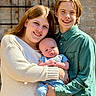 Koleson joined the competition — help win amazing prizes! baby, child, siblings, family, smiling, outdoor, portrait, people, young, casual_clothing, happy, holding, light, sunlight, brick_wall, person, face, head, toddler, teenager
