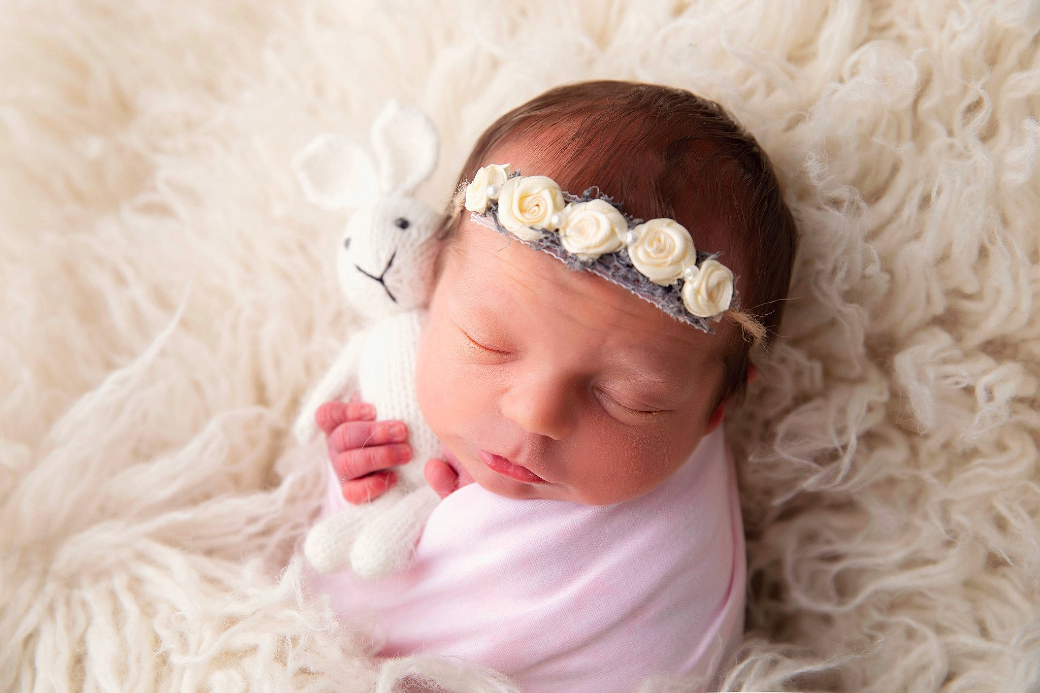 Phoebe is registered to the contest to win money with this photo: baby, baby_toddler_clothing, child, close_up, dress, embellishment, eyelash, fur, hair_accessory, hand, happy, headband, headgear, headpiece, headwear, jewellery, person, petal, pink, textile